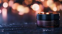 Luxurious black cosmetic cream jar with glitter effect on dark surface against blurred bokeh lights background, creating elegant beauty product photography.