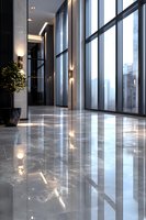 Modern luxury office hallway with floor-to-ceiling windows, polished marble floors reflecting natural light, and contemporary wall sconces creating elegant ambiance.