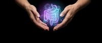 Protective hands surrounding glowing digestive system illustration representing gut health care and medical wellness concept on dark background.
