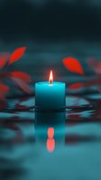 Glowing turquoise candle with orange flame reflecting in water, surrounded by red autumn leaves creating peaceful spa atmosphere for meditation and relaxation.