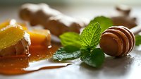 Chocolate macarons with fresh mint leaves and candied orange slices on rustic wooden surface, close-up view with soft natural lighting and selective focus.