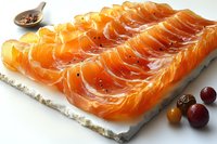 Fresh sliced smoked salmon arranged on white marble board with spices and garnish, vibrant orange color and glossy texture for food photography and menu design.