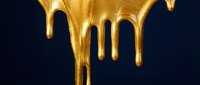 Liquid gold paint dripping down on dark navy background, shiny metallic texture with flowing drops and glossy streaks for luxury design.