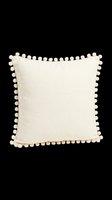 Cream linen throw pillow with decorative pom-pom trim, isolated on transparent background. Ready for home decor design, product mockups, interior styling, print-on-demand, and sublimation projects.