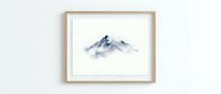 Minimalist watercolor mountain landscape artwork in wooden frame hanging on white wall for modern home decor and interior design inspiration.