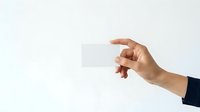 Hand holding blank white business card against neutral background, suitable for branding, corporate identity, and marketing mockup presentations.