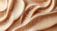 Luxurious caramel waves with sparkling bubbles create smooth flowing curves on beige background, abstract macro photography for cosmetic and beauty designs.