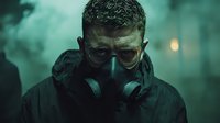 Dramatic portrait of person wearing protective gas mask in dark atmospheric environment with green smoke and moody lighting. Apocalyptic survival concept.
