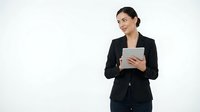 Professional businesswoman in black suit holding tablet computer against white background for corporate presentations and marketing materials.