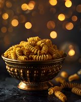 Fusilli pasta in vintage bronze bowl against dark background with golden bokeh lights creating festive atmosphere. Food photography for restaurant menu.