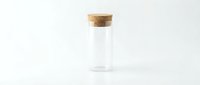 Empty glass vial with cork stopper on white background, laboratory equipment for scientific research, medical testing, sample storage.
