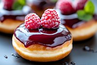 Fresh raspberry donut topped with dark chocolate glaze and ripe berries, extreme close up macro food photography showing sweet dessert details.