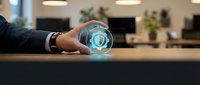 Businessman holding glowing crystal ball with digital hologram light effect on office desk, representing future vision, technology innovation, and strategic business planning.