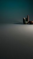 Minimalist ceramic pottery vessels on neutral surface with dramatic teal gradient lighting for modern interior design and home decor concepts.