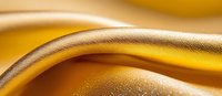 Luxurious golden waves with textured metallic surface create abstract flowing background pattern. Smooth curves and light reflections add depth and elegance.