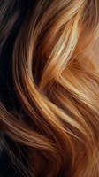 Close-up of wavy blonde and brown hair highlights showing natural texture and movement, suitable for beauty and hair care advertising campaigns.