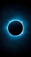 Total solar eclipse with bright blue corona glowing against dark sky background, dramatic astronomical phenomenon showing sun's atmosphere.