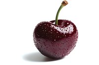 Fresh ripe dark red cherry with water drops and green stem isolated on white background, macro shot showing detailed texture and natural shine.