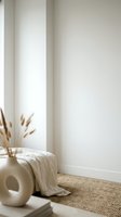 Minimalist neutral interior corner with cream walls, natural jute rug, ceramic vase with dried pampas grass and soft textile creating cozy scandinavian home decor.