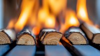 Wooden logs burning in fireplace with vibrant orange flames, creating warm ambiance for cozy home atmosphere during cold season.