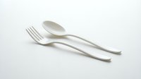 White plastic fork and spoon set isolated on white background for eco-friendly dining and food service applications.