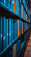 Rows of blue and orange books on library shelves create diagonal perspective with selective focus and moody lighting for educational or literary concepts.