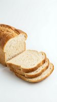 Fresh sliced white bread loaf with golden crust on clean background for bakery and food photography projects.
