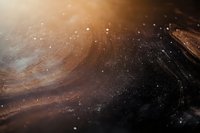 Abstract cosmic background with golden brown nebula and stardust particles floating in dark space, creating atmospheric celestial scenery for astronomy designs.