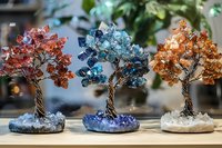 Handcrafted wire trees adorned with colorful crystal stones on amethyst bases create mystical home decor pieces that bring natural elements indoors.