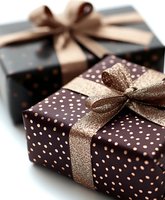 Elegant gift boxes wrapped in dark brown polka dot paper with shimmering gold ribbons, perfect for special occasions and holiday celebrations.
