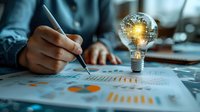 Creative business concept with glowing light bulb containing digital Earth above financial charts and graphs, perfect for innovation, global strategy, and business intelligence presentations.
