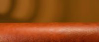 Closeup of human arm skin with reddish-orange tone, showing texture and natural surface details. Suitable for medical, dermatology, healthcare, and educational content.