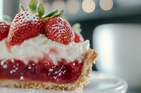 Fresh strawberry pie slice with whipped cream and berry filling on flaky crust, macro food photography with soft bokeh background highlights.