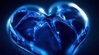 Glowing blue heart shape formed by liquid droplets and light reflections creating magical romantic atmosphere. Macro photography with dark background.