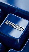 Approved button on blue keyboard key with metallic text, representing acceptance, confirmation, and authorization for business applications.