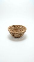 Handwoven wicker basket bowl isolated on white background for home decor and storage solutions.