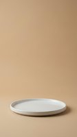 White ceramic plate on neutral beige background, isolated product shot for tableware, dinnerware, and kitchen design mockups.