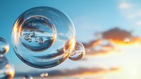 Transparent water bubbles floating in sky at sunset with reflections of clouds and golden light.