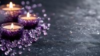 Glowing candles surrounded by purple amethyst crystals on dark textured background create mystical spa atmosphere. Wellness and meditation concept.