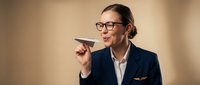 Middle-aged male professional with glasses and dark hair in business attire holding paper airplane, representing innovation, creativity, and forward-thinking business solutions for corporate presentations.