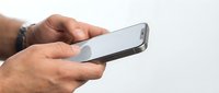 Man holding smartphone with blank screen, isolated on white background for app mockup and mobile technology design projects.