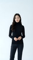 Young Asian woman in black turtleneck sweater and dark pants standing confidently against white background for professional business portrait.