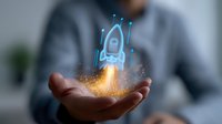 Glowing blue holographic rocket launching from open palm with orange flame effect against blurred office background, representing business startup and innovation.