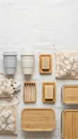 Eco-friendly bathroom and kitchen essentials arranged flat lay featuring reusable containers, wooden soap dishes, natural fiber pouches and sustainable home organization products.