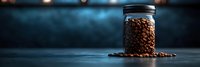 Glass jar filled with roasted coffee beans on dark surface with warm lighting. Coffee storage container for kitchen, cafe, restaurant use.