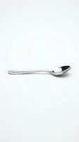 Single silver spoon isolated on white background for kitchen utensil design and culinary projects.