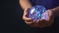 Hands holding glowing brain with neural network connections representing artificial intelligence, machine learning and digital innovation concepts.