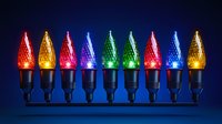 Colorful LED C9 Christmas string lights with textured bulbs glowing in red, gold, pink, blue and green against dark background, arranged in festive holiday display.