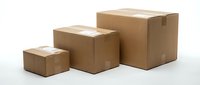 Three sealed cardboard shipping boxes in increasing sizes arranged in ascending order on white background, suitable for logistics, delivery, storage, and packaging design projects.