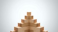 Wooden blocks stacked in pyramid formation on white background, representing growth, stability, and business success for corporate presentations and marketing materials.